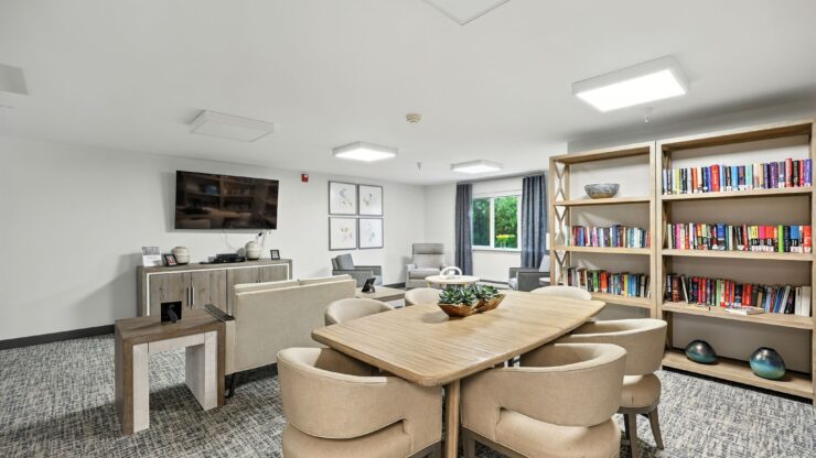 A welcoming space filled with natural light, featuring comfortable seating and a vibrant bookshelf.