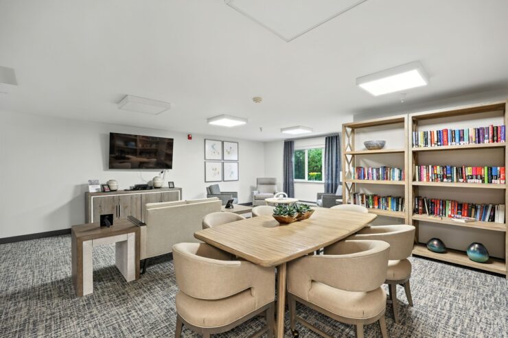 A welcoming space filled with natural light, featuring comfortable seating and a vibrant bookshelf.