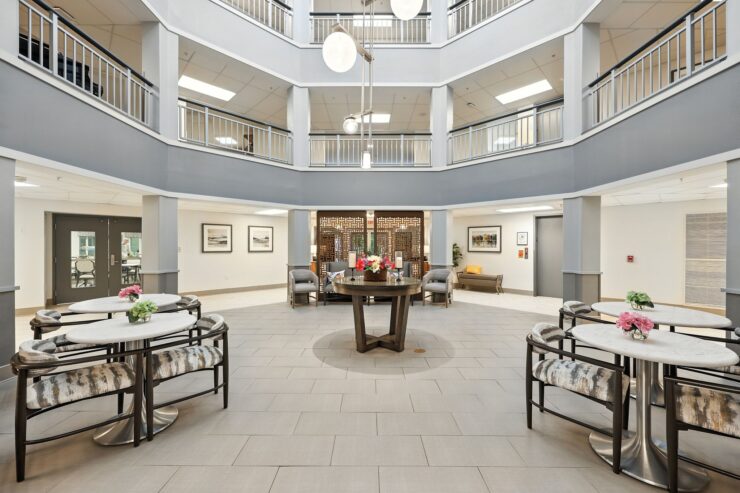 Bright and inviting common area, featuring elegant seating and floral accents, fostering community connections.