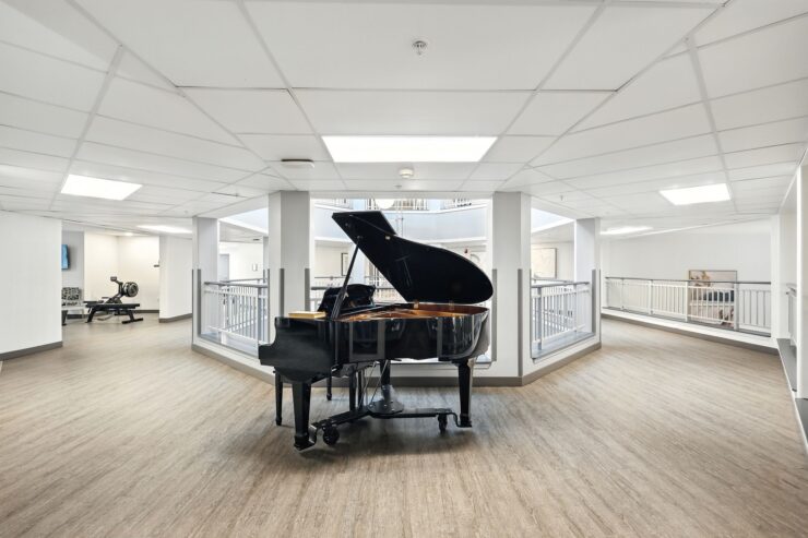 A spacious, inviting common area featuring a grand piano, perfect for gatherings and musical enjoyment.
