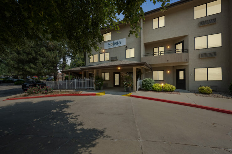A welcoming entrance invites residents to a vibrant community filled with warmth and companionship.
