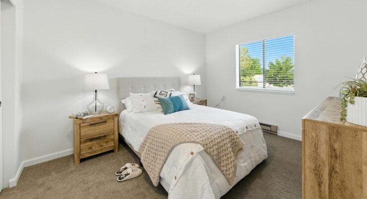 Bright and inviting, this serene bedroom offers comfort and a welcoming atmosphere for residents.