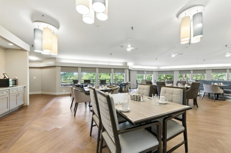 A welcoming dining area filled with light, promoting community and comfort among residents.
