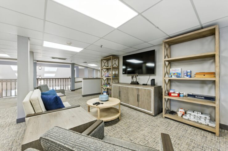 A welcoming lounge with comfortable seating, bright lighting, and a warm atmosphere for community gatherings.