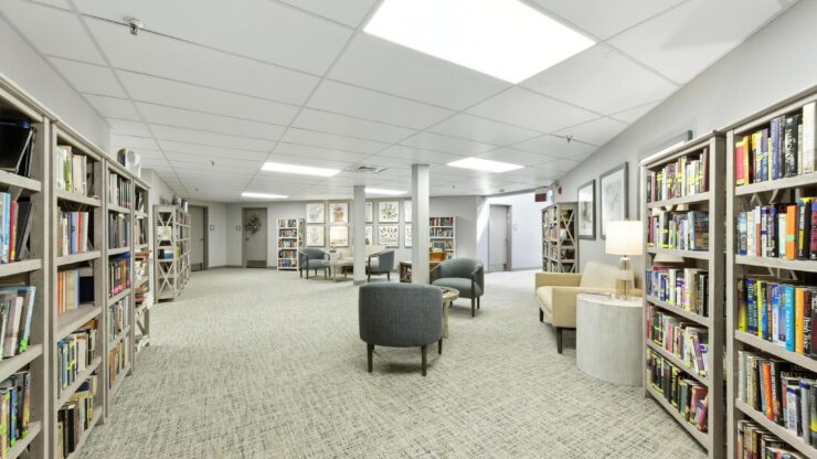 A welcoming library space filled with books, comfortable seating, and soft lighting, perfect for community gatherings.