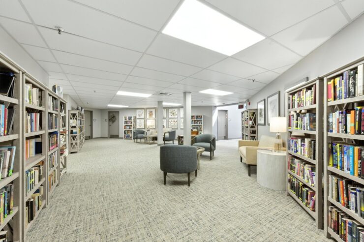 A welcoming library space filled with books, comfortable seating, and soft lighting, perfect for community gatherings.