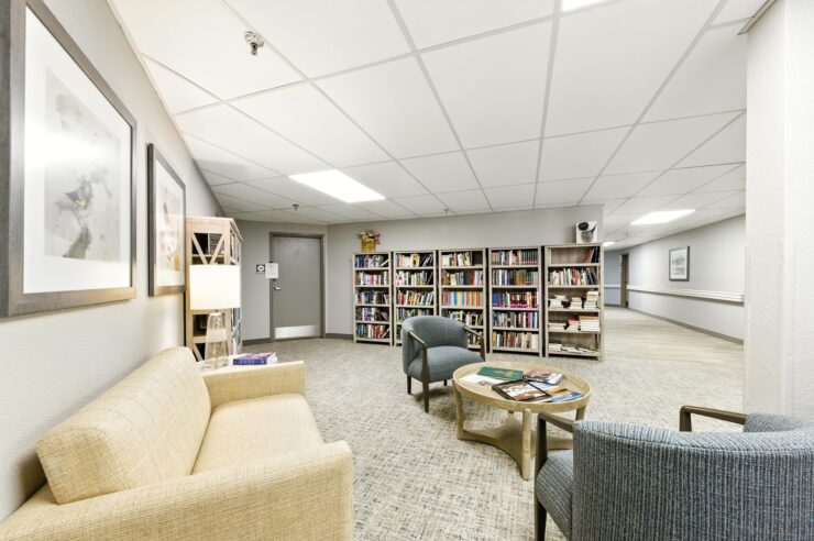 A welcoming lounge area with comfortable seating and a well-stocked bookshelf, perfect for community gatherings.