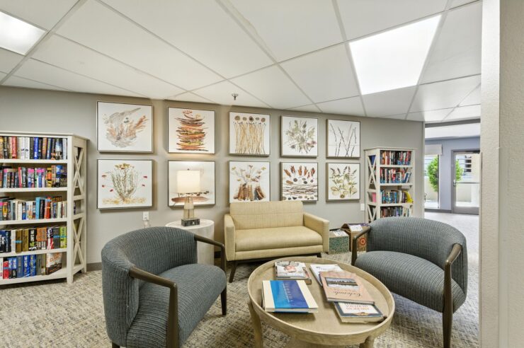 A welcoming lounge filled with natural light, inviting seating, and beautiful artwork, perfect for community gatherings.