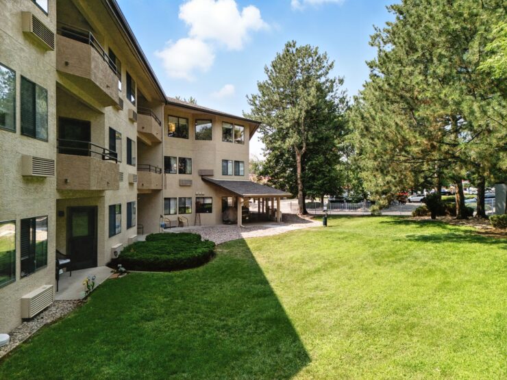 A welcoming community space surrounded by lush greenery, perfect for relaxation and socializing.