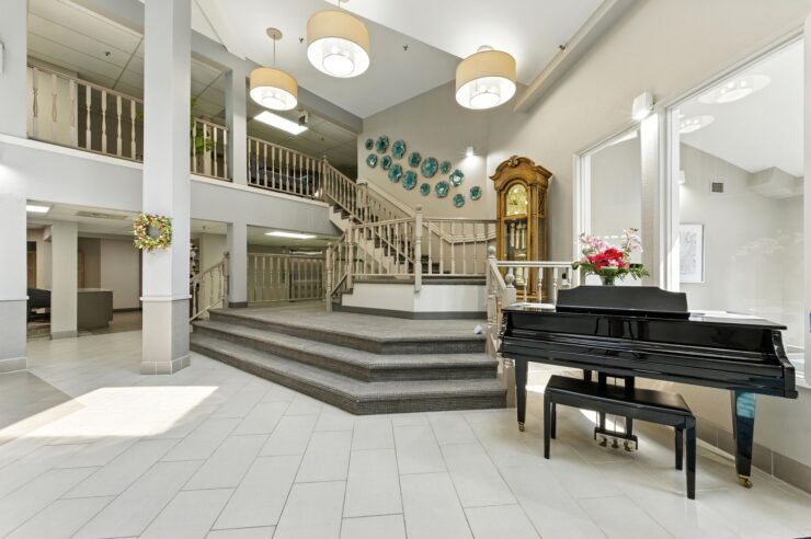 A welcoming entrance features elegant decor, natural light, and inviting spaces for community gatherings.