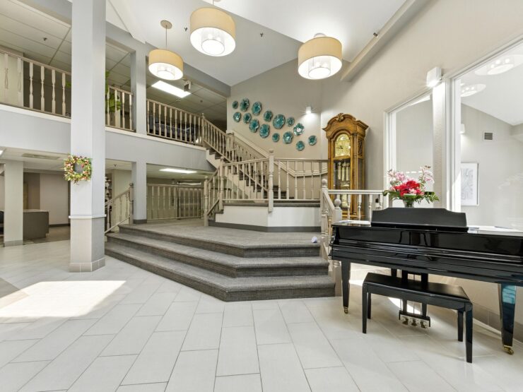 A welcoming entrance features elegant decor, natural light, and inviting spaces for community gatherings.