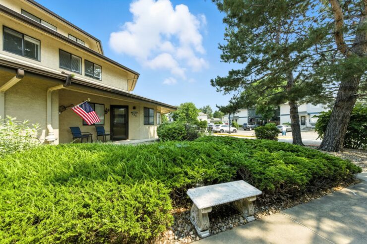 A welcoming outdoor space with lush greenery, inviting seating, and a friendly atmosphere for community gatherings.