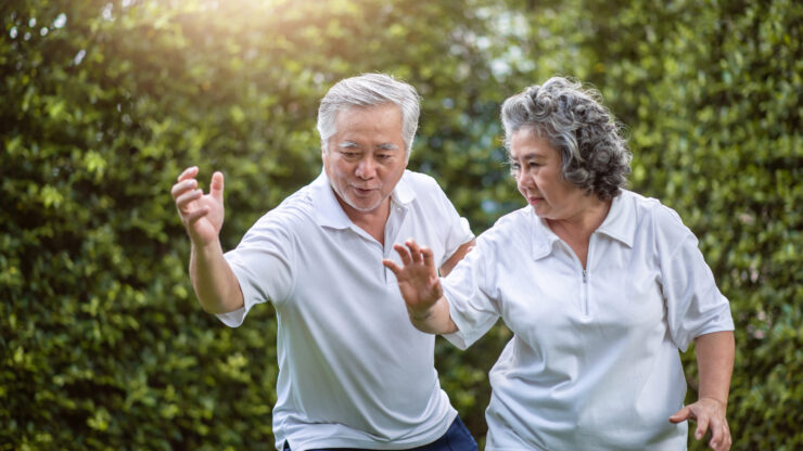 Engaged seniors enjoy a lively moment outdoors, showcasing an active and supportive community spirit.