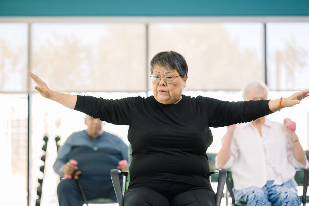 A vibrant exercise class fosters community and connection among residents, promoting well-being and joy.