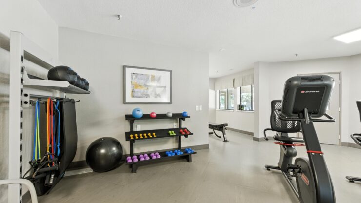 A bright fitness area filled with diverse equipment, inviting residents to stay active and engaged.