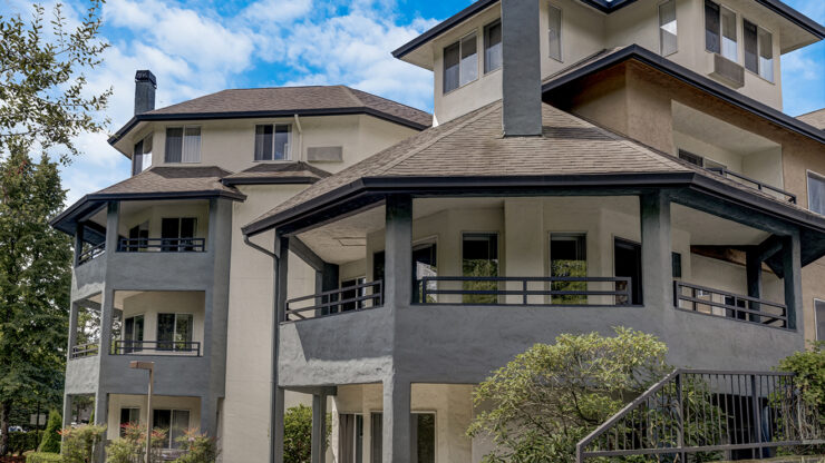 A welcoming community space with inviting architecture, surrounded by greenery and bright skies.