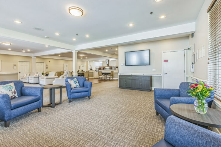 Bright, inviting lounge with comfortable seating, fostering community and warmth for residents.
