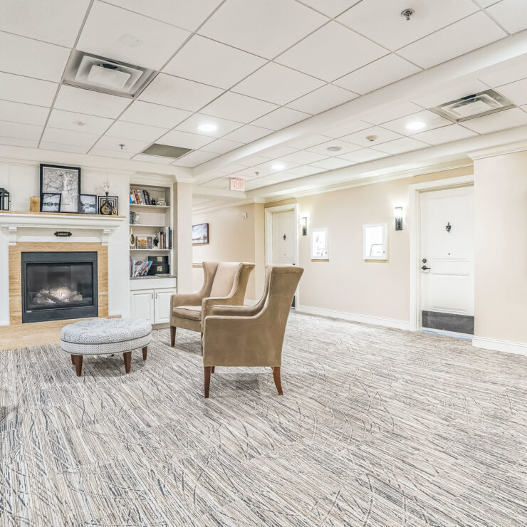 A welcoming lounge with comfortable seating, a warm fireplace, and vibrant artwork, perfect for community gatherings.