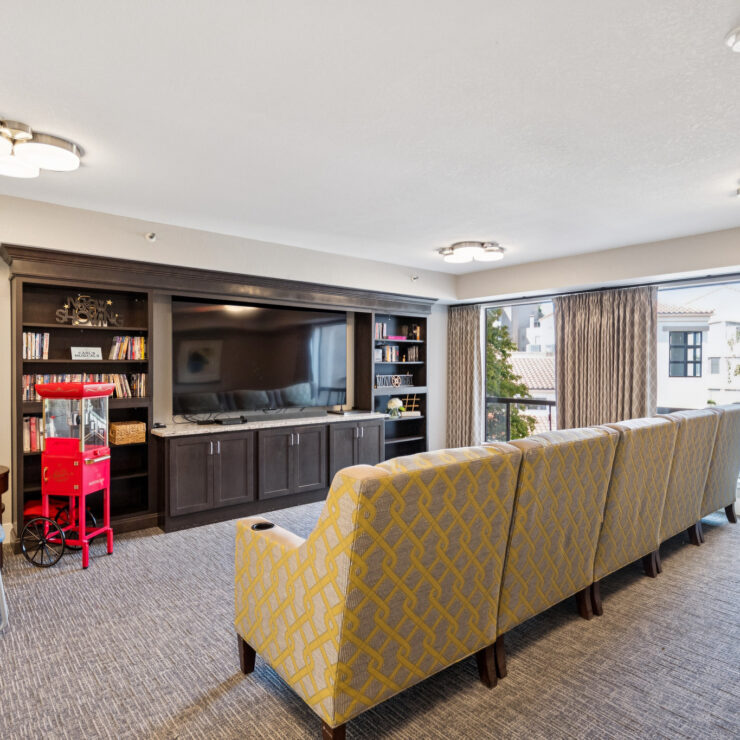 A welcoming lounge with comfortable seating, a large TV, and natural light, perfect for community gatherings.