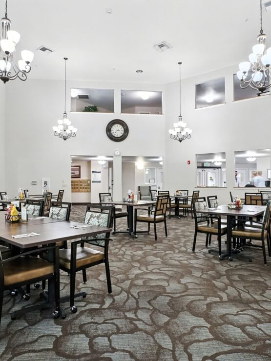 Bright, welcoming dining area with elegant chandeliers, inviting tables, and a sense of community.