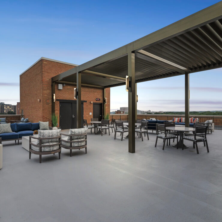 A spacious rooftop terrace invites relaxation with comfortable seating and beautiful views, fostering community.