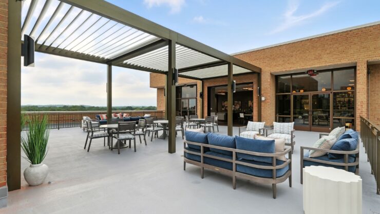A welcoming terrace with comfortable seating invites relaxation and community gatherings, offering scenic views.