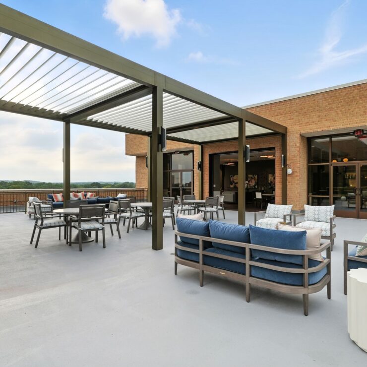 A welcoming terrace with comfortable seating invites relaxation and community gatherings, offering scenic views.