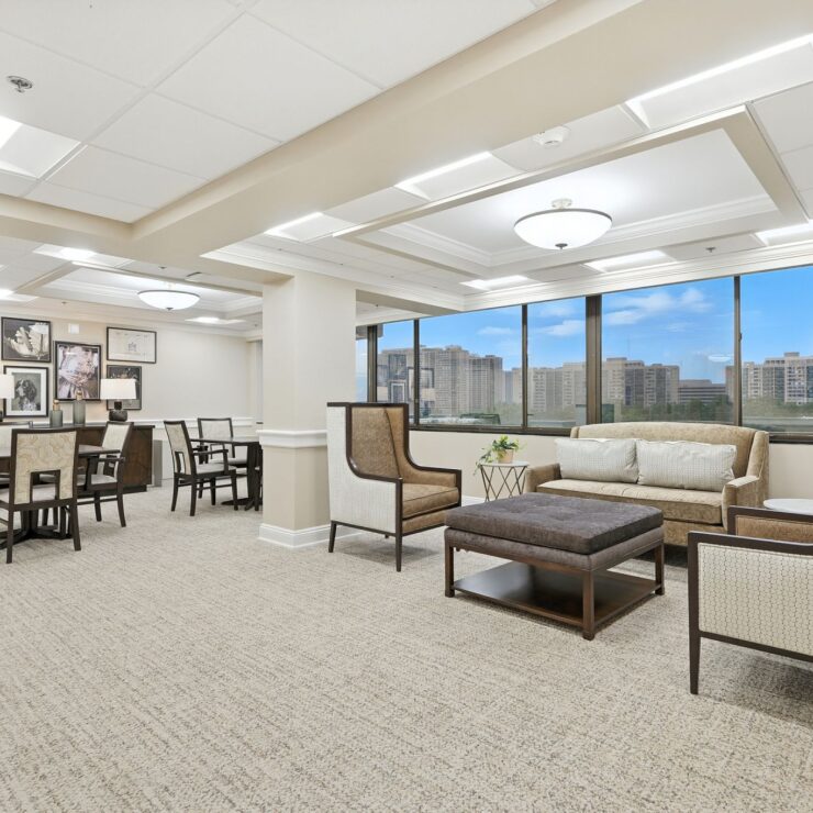 Bright and inviting common area, fostering connection and comfort with scenic views and cozy seating.