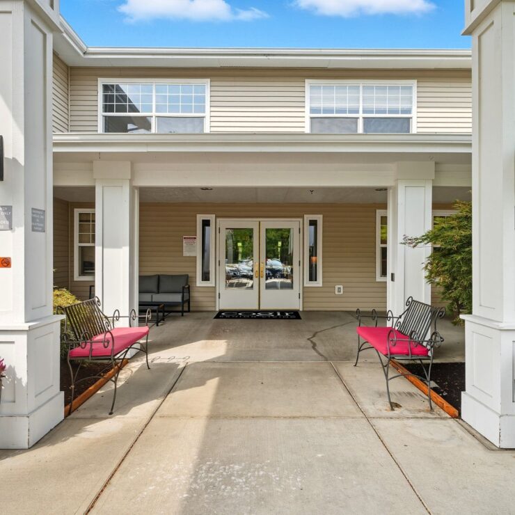Welcoming entrance with comfortable seating, greenery, and bright natural light at retirement home.