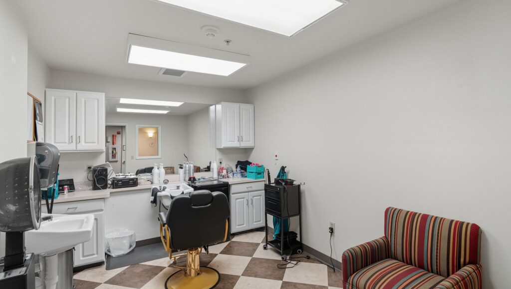 A welcoming salon space, featuring a comfortable chair and bright lighting, perfect for community gatherings.