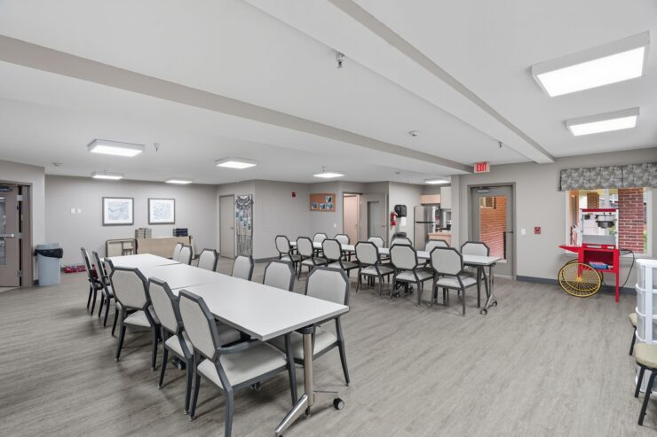 A spacious, inviting common area fosters community connections, featuring comfortable seating and a warm atmosphere.
