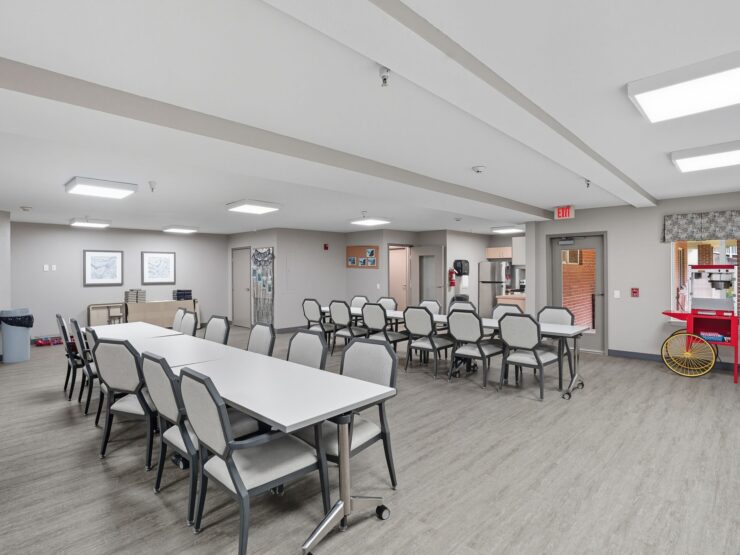 A spacious, inviting common area fosters community connections, featuring comfortable seating and a warm atmosphere.