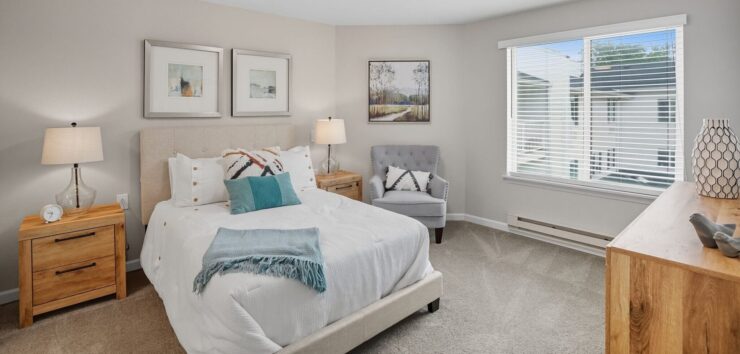 Bright, inviting bedroom designed for comfort, featuring soft furnishings and warm décor.