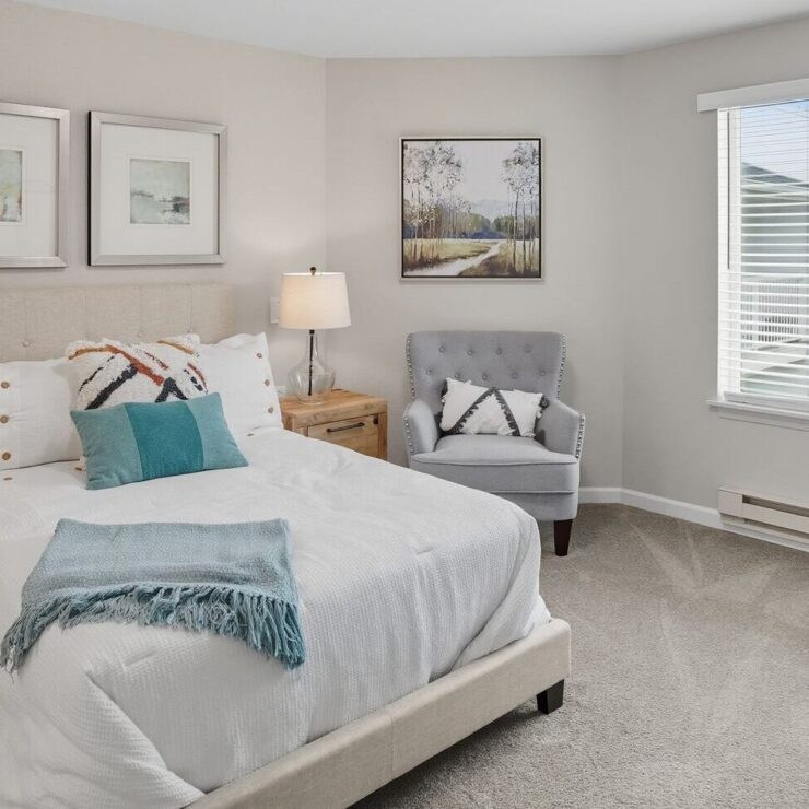 Bright, inviting bedroom designed for comfort, featuring soft furnishings and warm décor.
