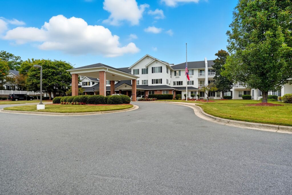 Well-maintained retirement community with landscaped grounds and welcoming entrance driveway.
