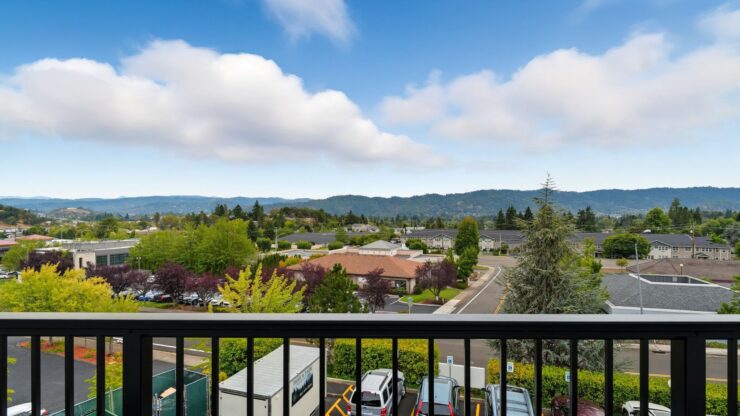 A serene view overlooking vibrant greenery and gentle hills, fostering a sense of community and peace.