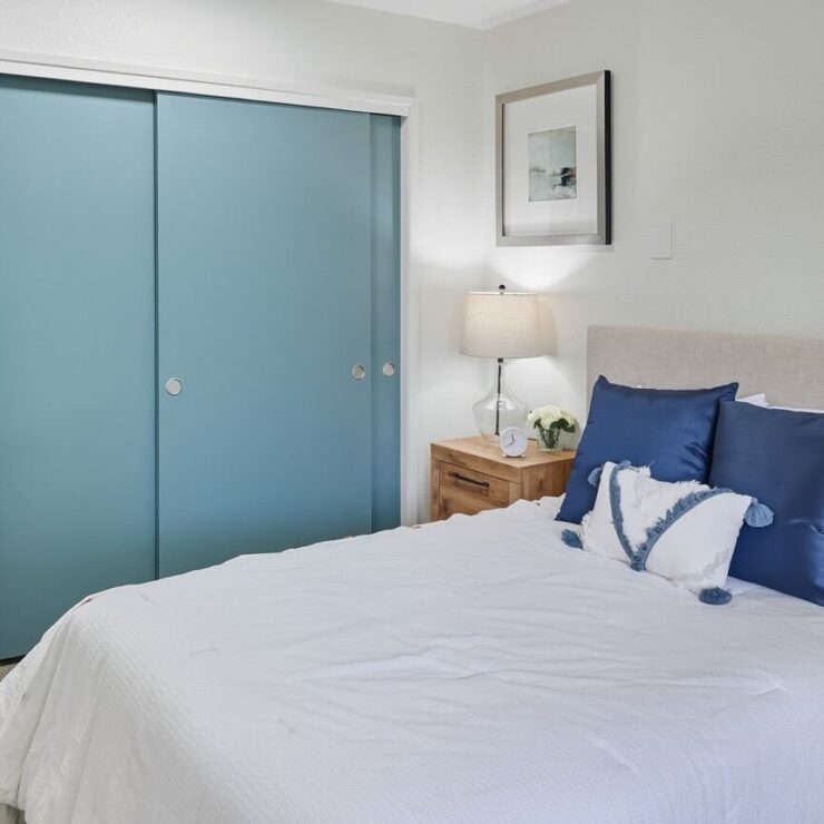 A serene bedroom featuring soft colors and inviting decor, perfect for comfort and community living.