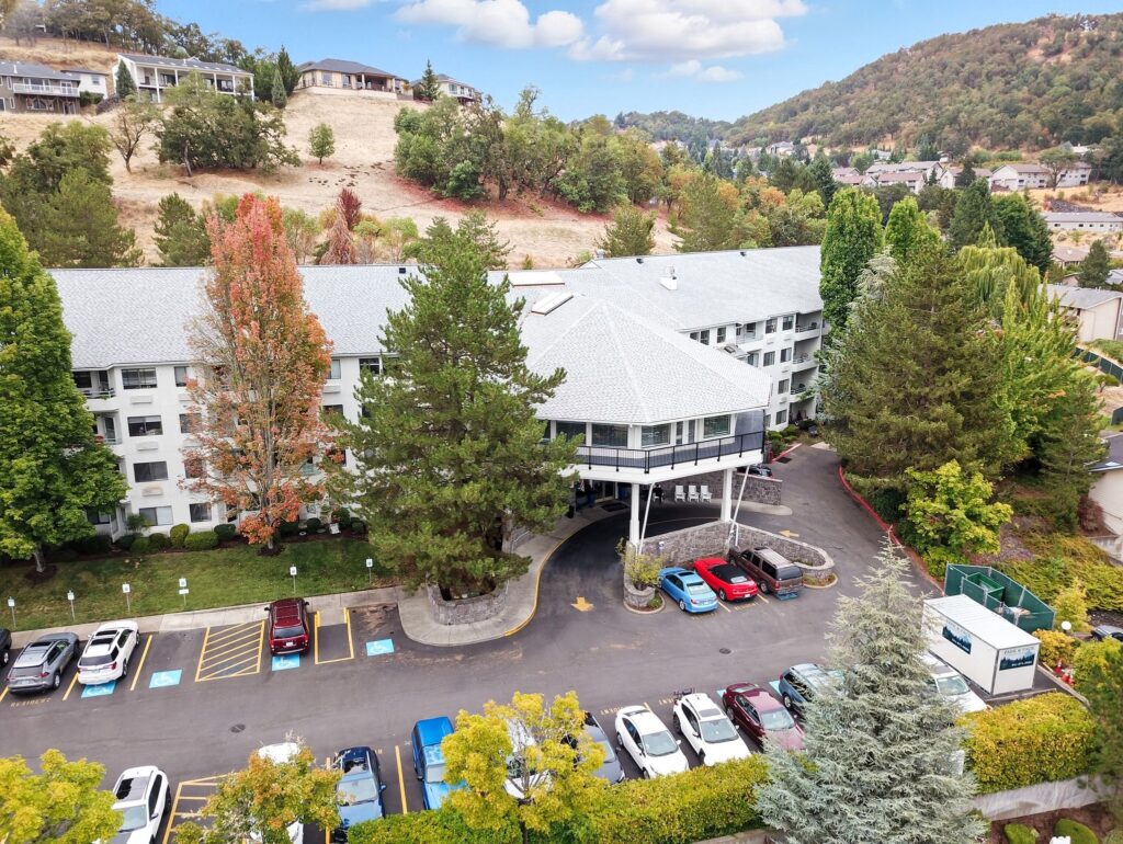 Retirement community nestled among trees and hills, offering peaceful and welcoming surroundings.