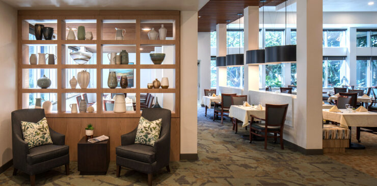 Inviting dining area with comfortable seating, natural light, and decorative accents promoting community.