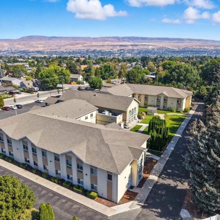 Spacious retirement community surrounded by greenery and scenic mountain views.
