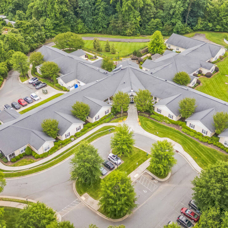 Well-maintained retirement community surrounded by lush greenery and peaceful landscaping.