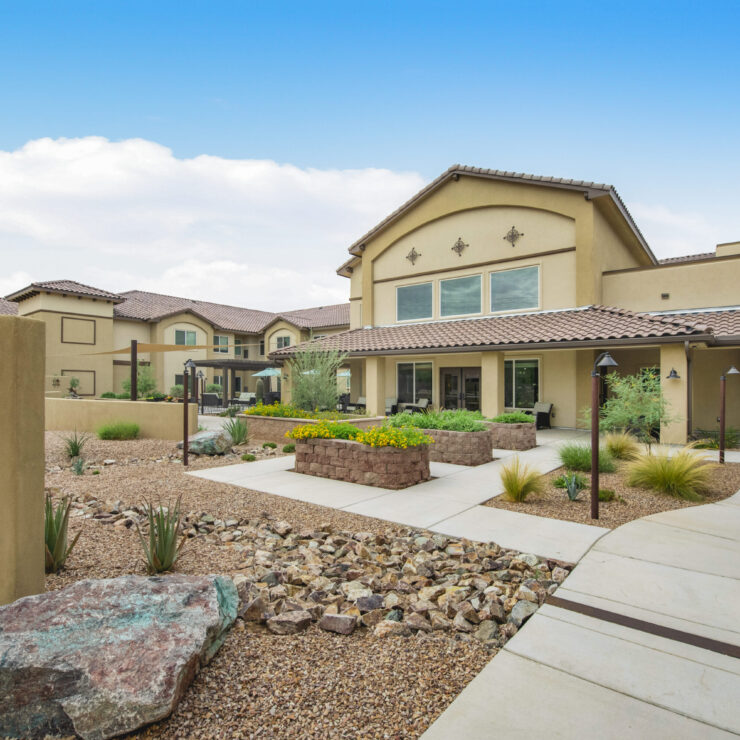 Well-maintained garden courtyard with shaded seating and desert landscaping for relaxation.