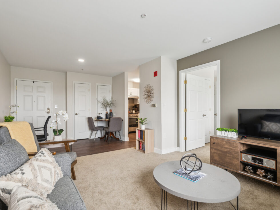 Bright and welcoming living space with comfortable seating, dining area, and homey decor.