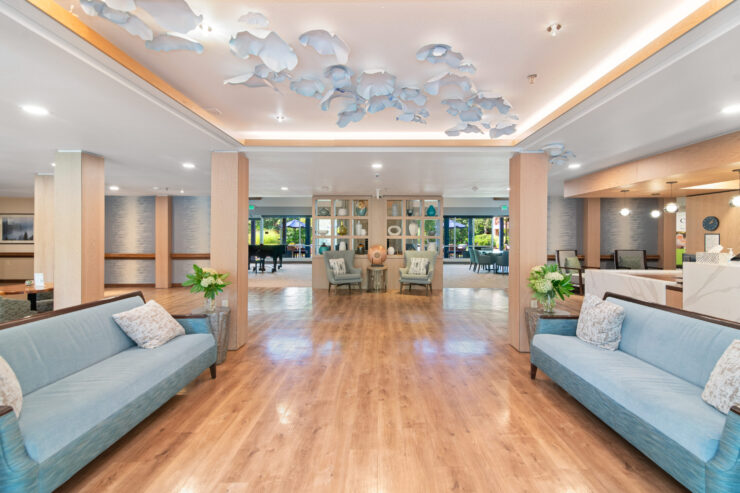 Spacious, inviting lounge with comfortable seating, natural light, and calming decor for socializing and relaxation.