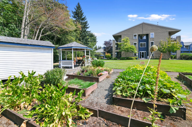 Well-maintained garden beds and a shaded gazebo complement the peaceful community grounds.