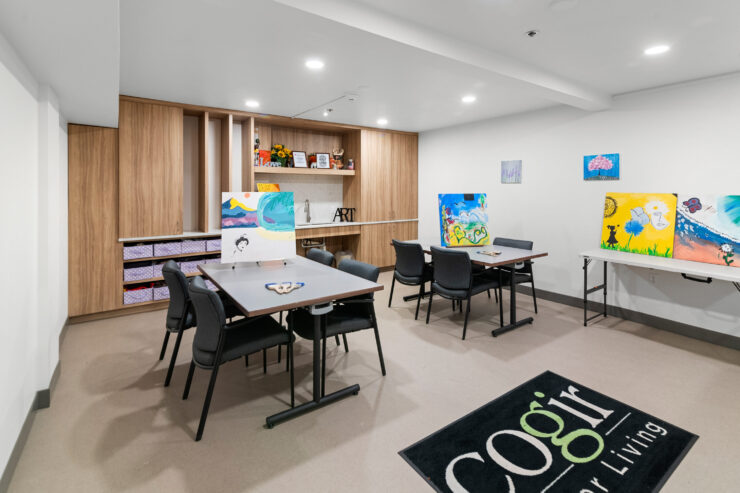 Bright art room with paintings and comfortable seating fostering creativity and community spirit