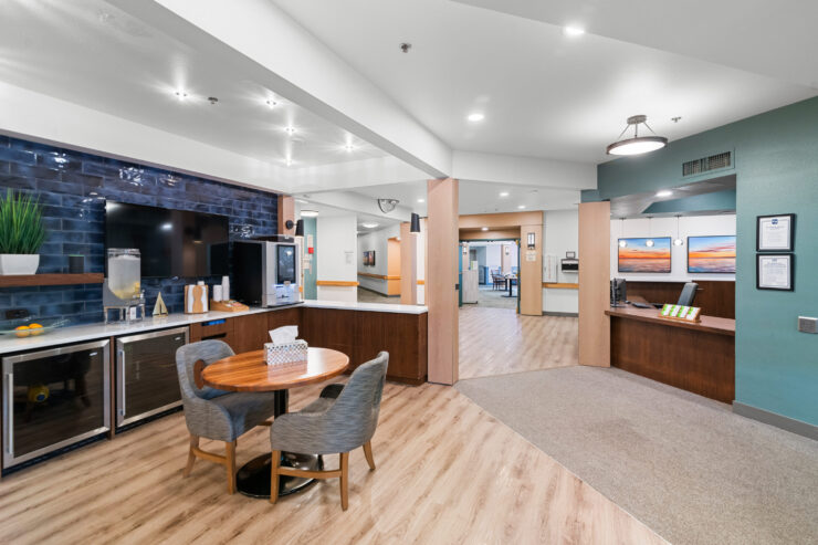 Welcoming community space with seating, refreshment area, and bright, open design.