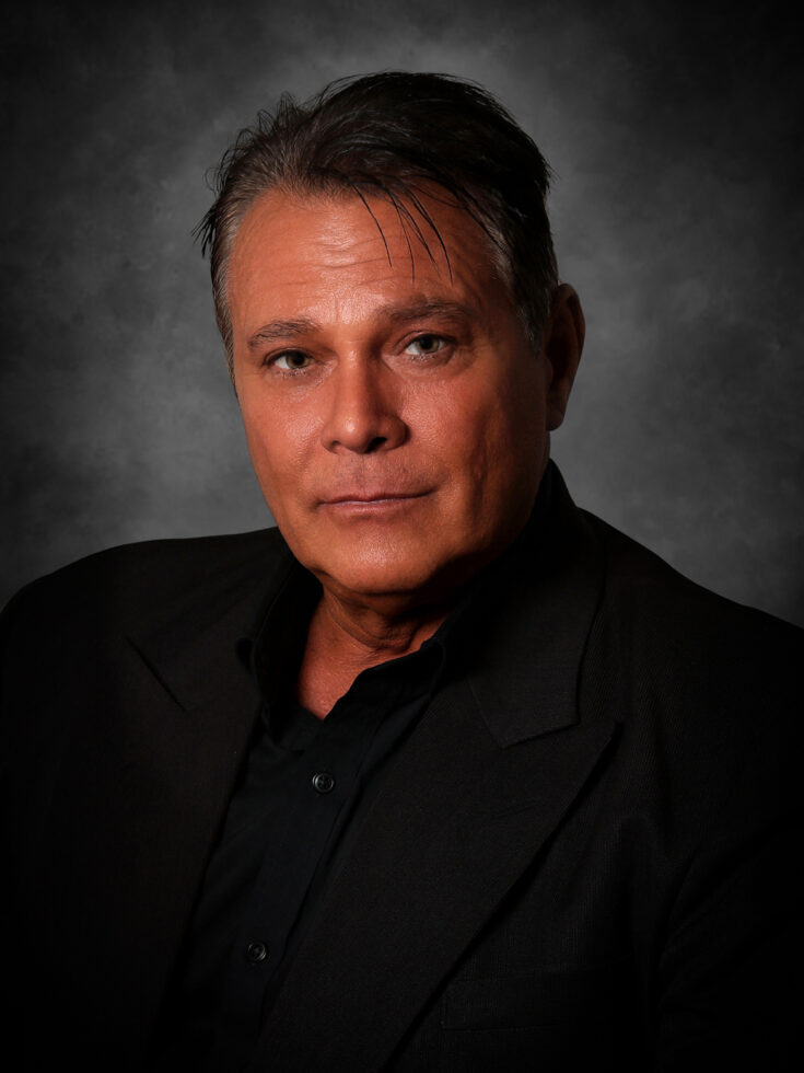 A thoughtful individual exudes warmth and confidence, embodying a welcoming community spirit.