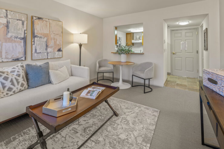 Welcoming living area with comfortable seating, soft lighting, and a small dining space.