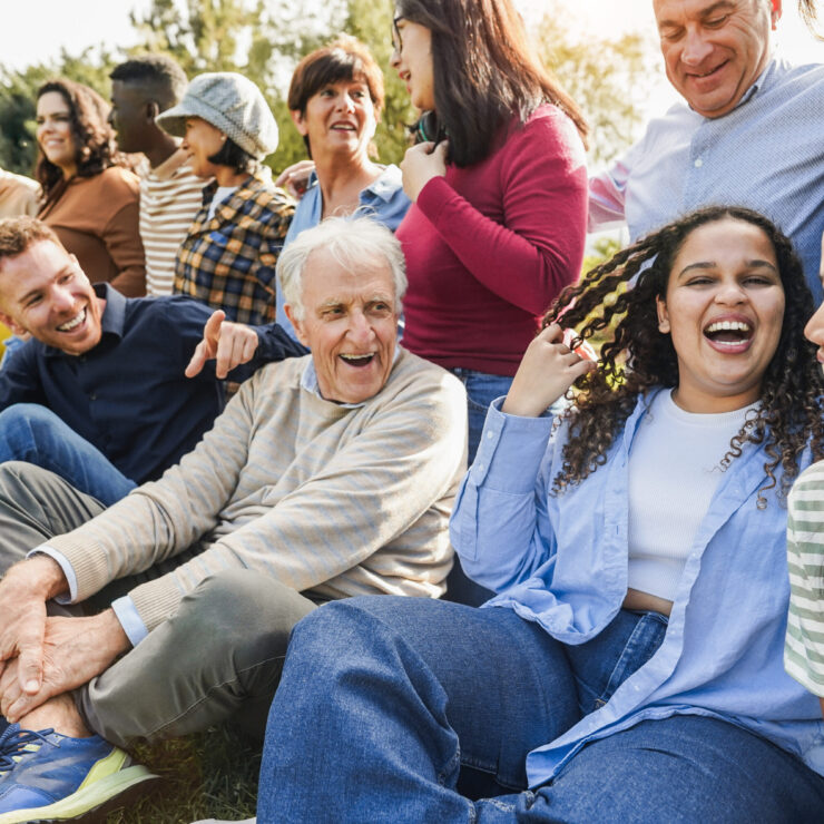 A joyful gathering in a sunny park, showcasing laughter and connection among diverse friends.